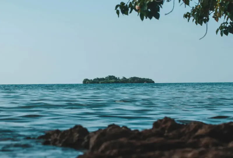 Small island offshore seen from the rocky coast of Negril, Jamaica: lawyers and advisers in Jamaica