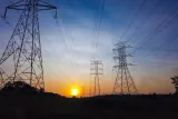 Electricity pylons silhouetted at sunset, illustrating whether fines and penalties are tax deductible after the ScottishPower ruling