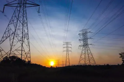 Electricity pylons silhouetted at sunset, illustrating whether fines and penalties are tax deductible after the ScottishPower ruling