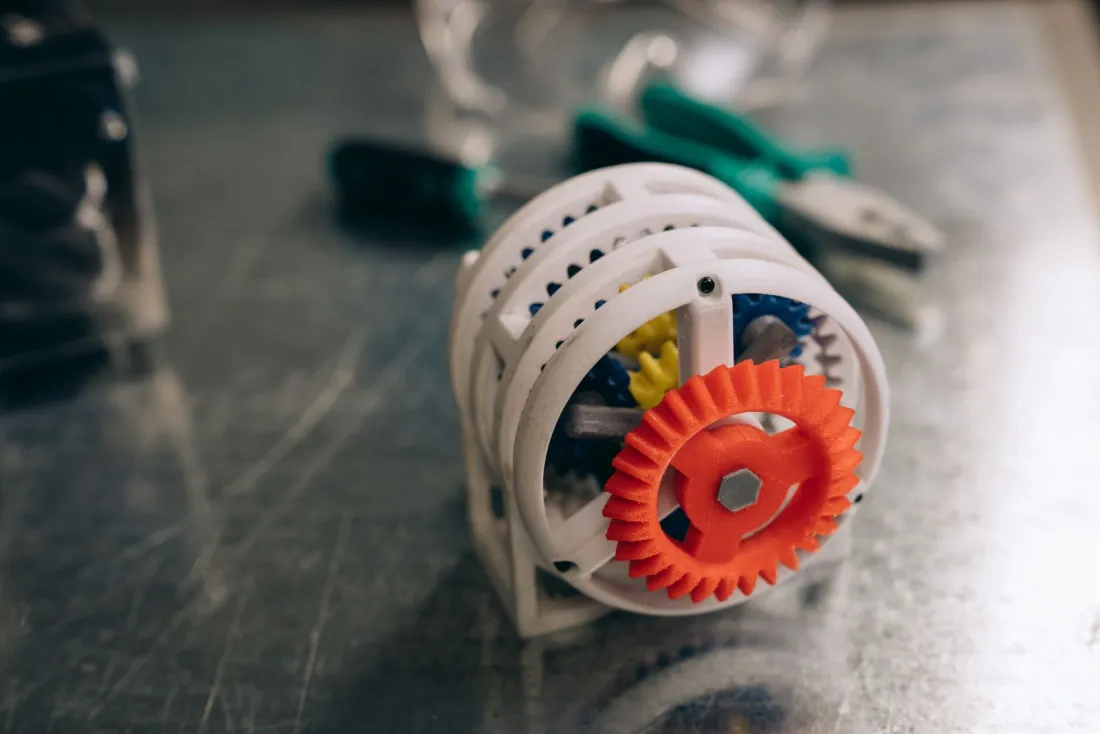 3D printed gear prototype on a metal workbench, illustrating how to patent an idea internationally