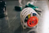 3D printed gear prototype on a metal workbench, illustrating how to patent an idea internationally