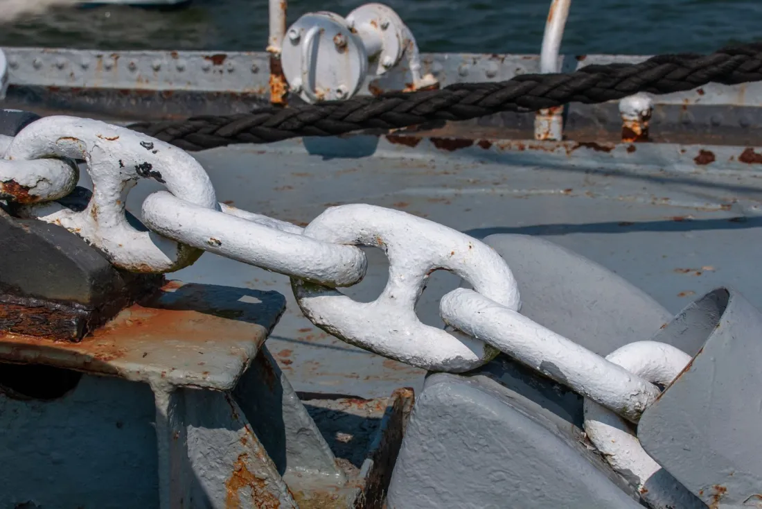 Anchor chain on the deck of a docked ship, representing security given for the release of an arrested ship