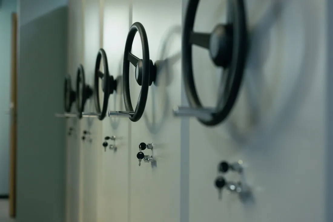Row of locked steel cabinets with keys, illustrating how an e-money institution must safeguard customer funds in a segregated account