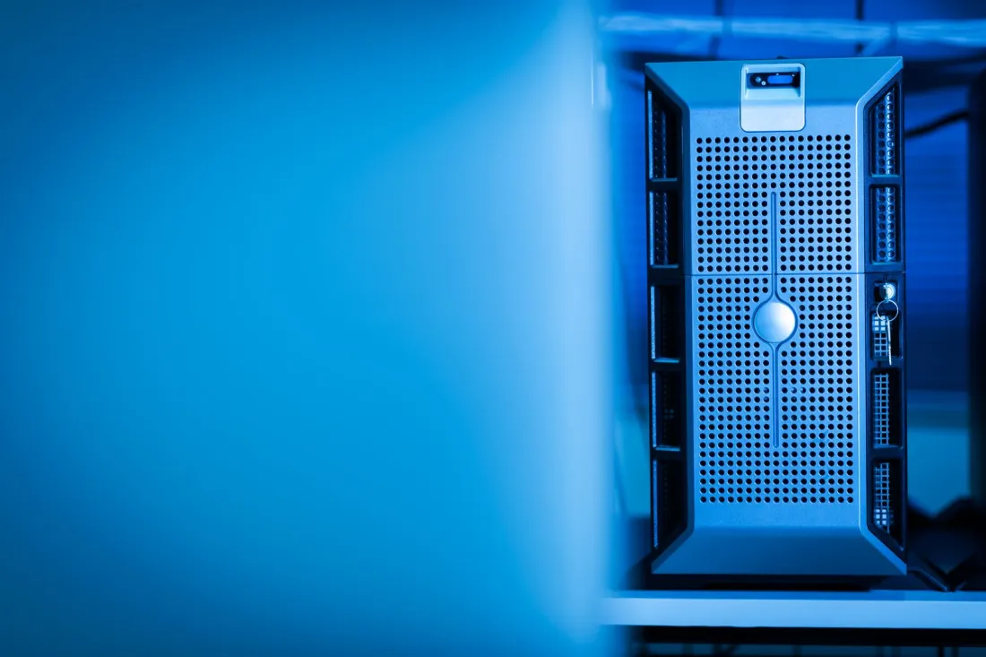 Server tower in a blue-lit data centre, illustrating the reporting system error behind the Coinbase Ireland safeguarding shortfall