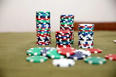 Stacks of casino chips on a green table, illustrating whether online gambling is legal in the Netherlands after the Ksa's record EOD Code fine