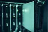 Server racks in a data centre with status lights, illustrating how to respond to a data breach