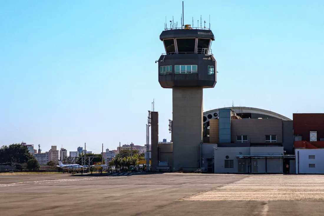 Airport control tower beside an empty apron, illustrating the Dublin Airport passenger cap ruling on slot capacity