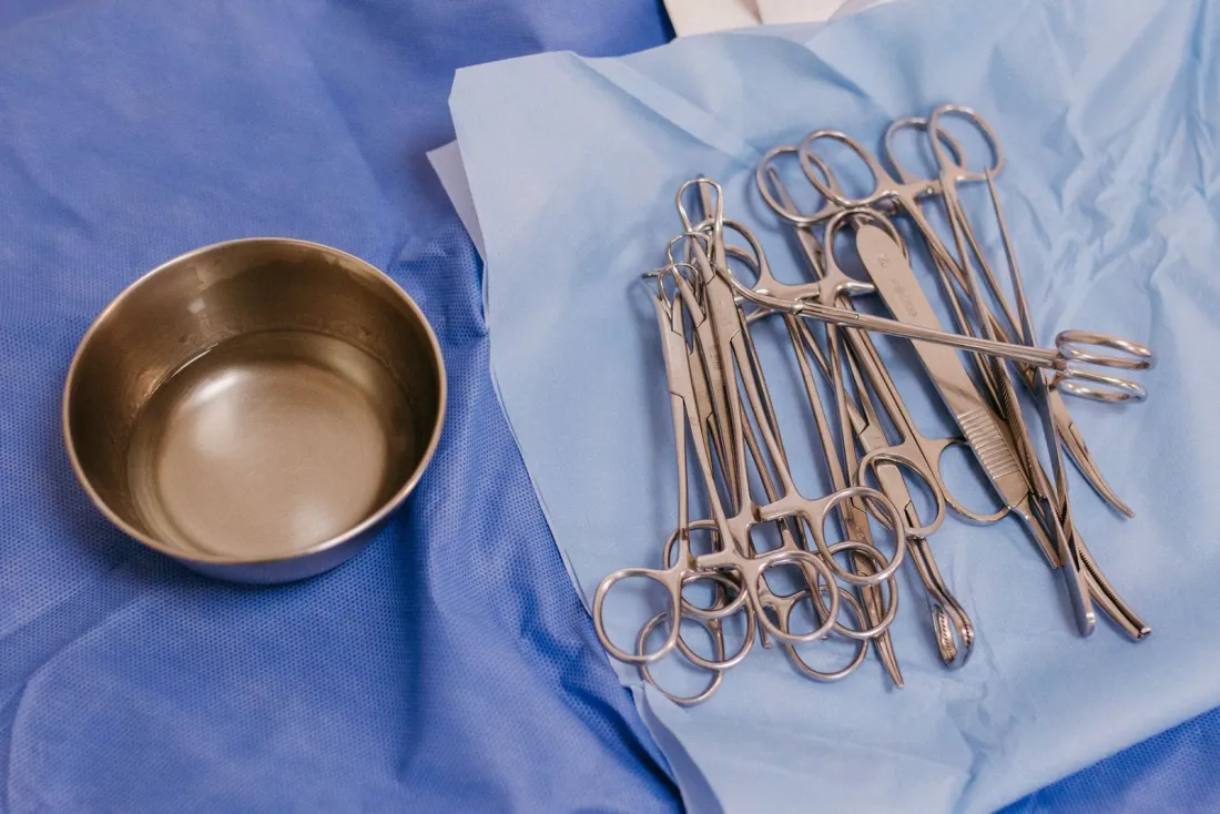 Sterile surgical instruments on blue drapes beside a steel bowl, illustrating whether medical devices need to be CE marked