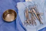 Sterile surgical instruments on blue drapes beside a steel bowl, illustrating whether medical devices need to be CE marked