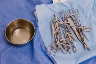 Sterile surgical instruments on blue drapes beside a steel bowl, illustrating whether medical devices need to be CE marked