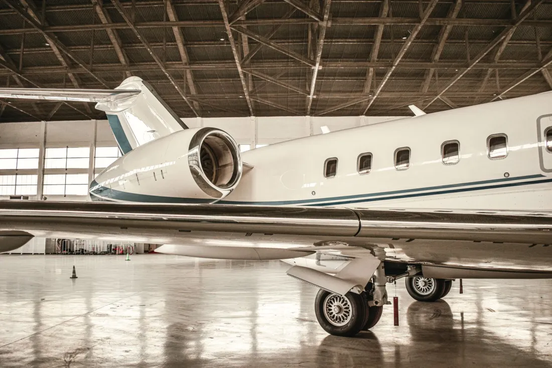 Business jet engine and wing in a hangar, illustrating common mistakes to avoid when you buy a private jet for the first time