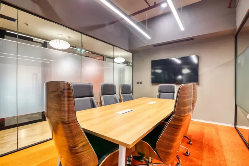 Empty boardroom with a wooden table and leather chairs, illustrating how to set up a family office