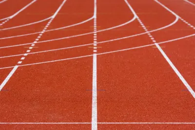 Empty red athletics track with white lane lines, illustrating the Koki Ikeda doping ban overturned by CAS