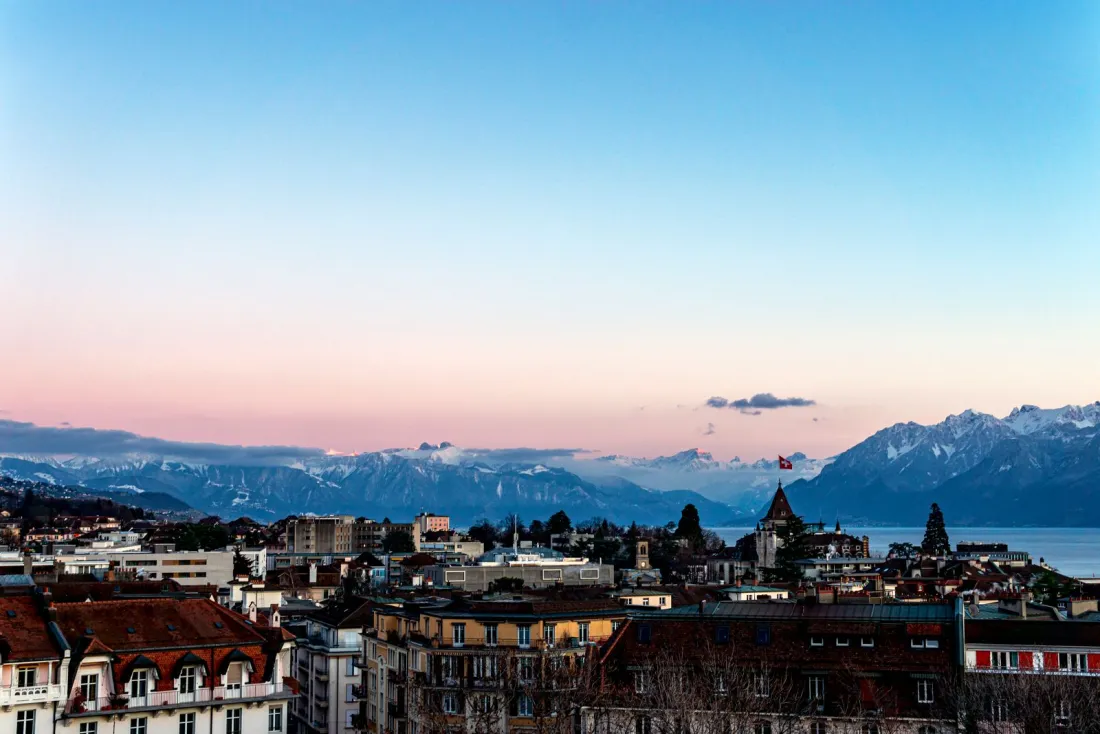 Lausanne skyline above Lake Geneva at dusk, home of the Court of Arbitration for Sport that overturned the Koki Ikeda doping ban