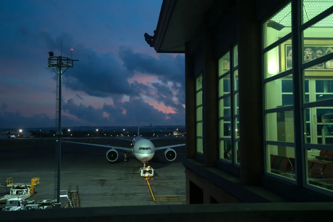Widebody airliner parked on a stand beside a terminal at dusk, illustrating wet lease vs dry lease aircraft arrangements