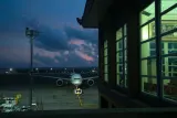 Widebody airliner parked on a stand beside a terminal at dusk, illustrating wet lease vs dry lease aircraft arrangements