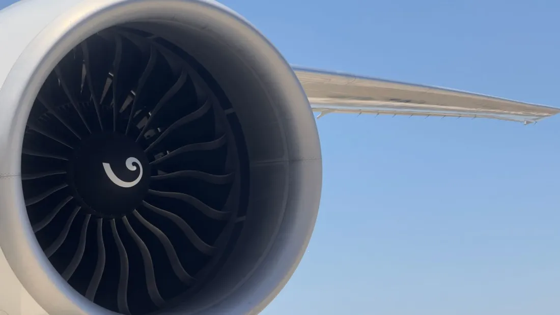 Close-up of an aircraft jet engine and wing against a blue sky, illustrating operational control in a wet lease vs dry lease