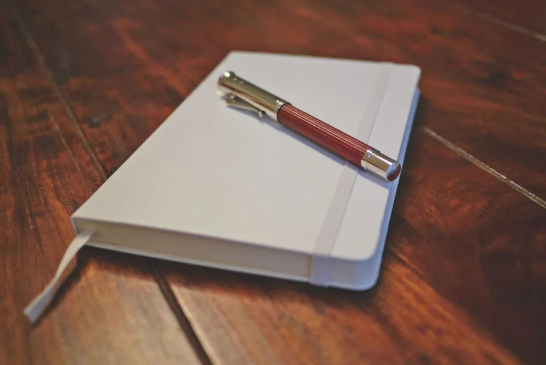 Pen resting on a closed notebook, illustrating image rights contracts and the April 2027 image rights tax change