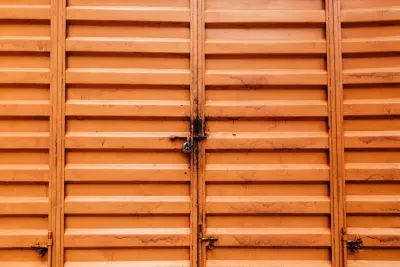 Padlocked orange metal doors on a closed business, illustrating company insolvencies in September 2026 in England and Wales