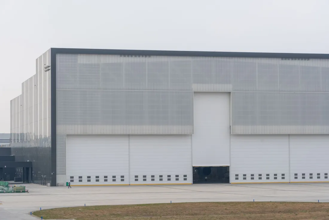 Large modern warehouse with loading doors, an example of UK commercial property that needs due diligence before a foreign company buys it