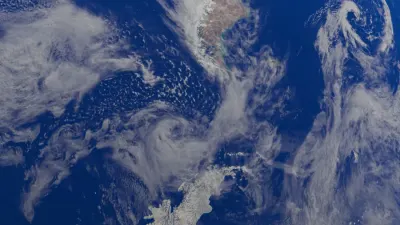 Satellite view of swirling storm clouds over deep blue ocean, illustrating the Jamaica catastrophe bond payout