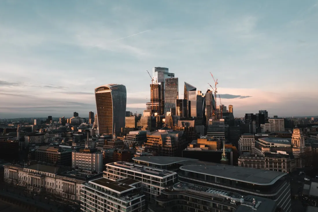 Aerial view of the City of London skyscrapers at sunset, illustrating the FCA rules on targeted support