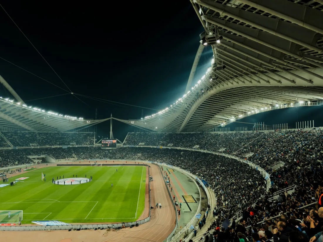 Floodlit football stadium at night, illustrating the sports event contracts at the centre of the Kalshi Utah lawsuit