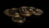 Gold bitcoin coins on a black surface, illustrating the $6.3bn Binance hack, the largest crypto theft on record