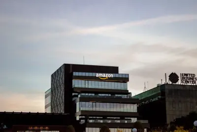 An Amazon logo on the side of an office building at dusk, illustrating the Amazon FTC fine over identity-theft records