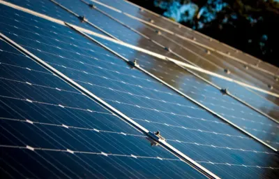 Close-up of angled solar panels reflecting sunlight, illustrating opportunities in the global energy transition