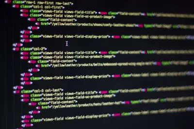 Close-up of website source code on a dark screen, illustrating data governance and security priorities