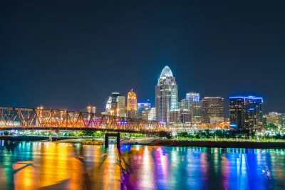 Colourful city skyline reflected in a river at night, illustrating the urban exodus myth in Midwest cities