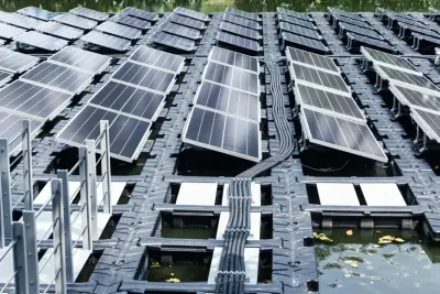 Rows of solar panels mounted on a floating platform over water, illustrating floating solar technology