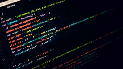 Close-up of suspicious JavaScript code on a dark screen, illustrating web-based cyber threats