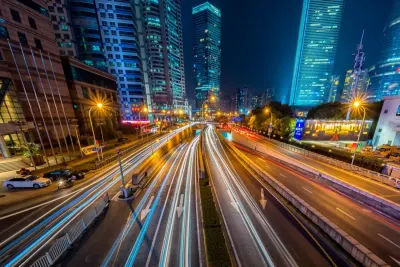 Long exposure traffic light trails streaming through a lit up city at night, illustrating strategies for boosting innovation