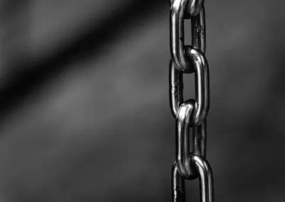 Close-up of a strong steel chain in black and white, symbolising organisational fortitude