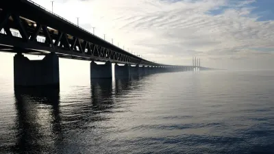 A long bridge stretching into misty water, symbolising bridging the digital divide