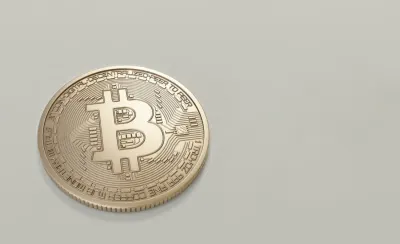 Gold coin engraved with the Bitcoin symbol on a plain background, illustrating proof of bitcoin wash trading