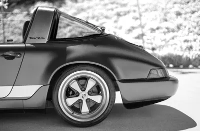 Rear wheel and bodywork of a classic Porsche Targa, evoking Everrati's electric-converted cars on the road to net zero