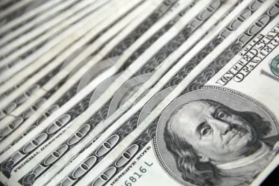 Close-up of a stack of hundred-dollar bills, illustrating global alternative investment allocations