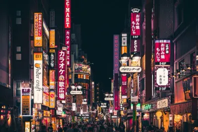 Neon-lit night street scene in an Asian city, illustrating optimism around credit risk management in Asia