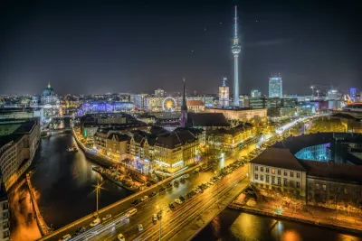 Illuminated German city skyline at night with a television tower, illustrating freelance regulation