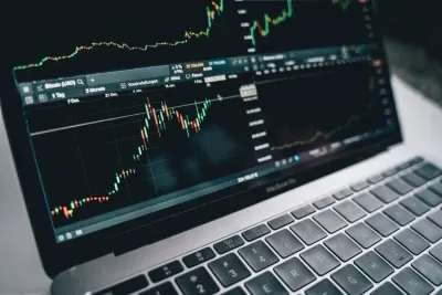 Laptop screen displaying a rising cryptocurrency trading chart, reflecting the rise of Gen Z investors