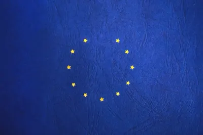 Close-up of the gold stars on an EU flag against a blue backdrop, illustrating no-deal Brexit fears