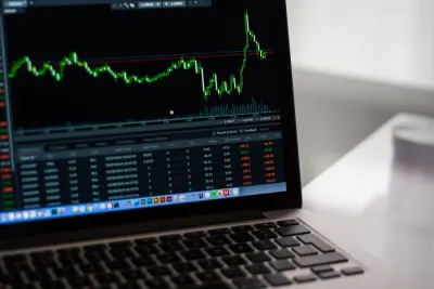 A laptop screen displaying a financial trading chart and figures, illustrating US fintech investment
