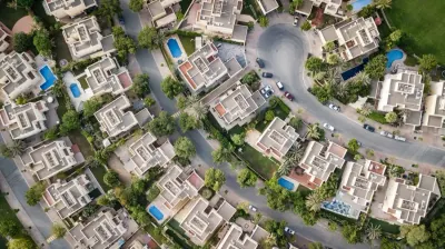 Aerial view of a suburban housing estate with pools and gardens, illustrating the hot 2021 housing market