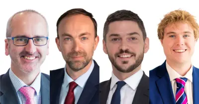 Four professional headshots of businessmen in suits and ties, for a law firm's Guernsey Press acquisition deal