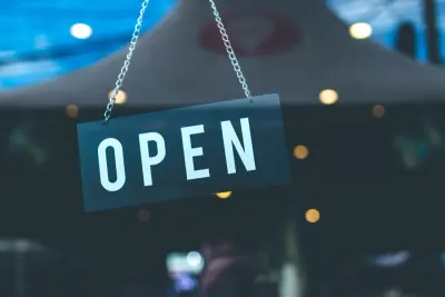 Open sign hanging in a cafe window, illustrating business resilience and recovery during lockdown