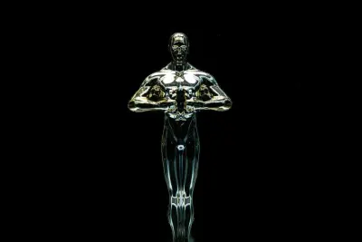 Gold award statuette lit against a black background, for the Global Awards 2024